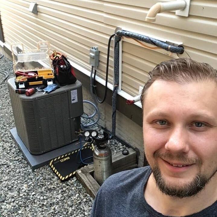 technician installs a heat pump